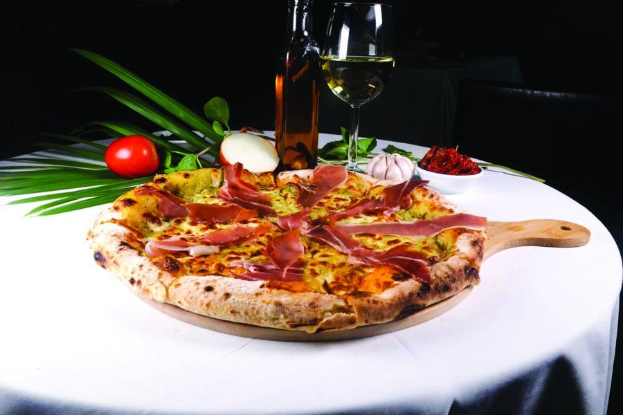 Parma ham pizza on a set table