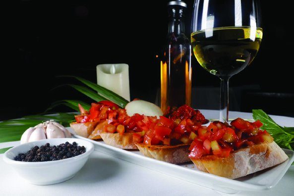 Bruschetta platter with a glass of wine